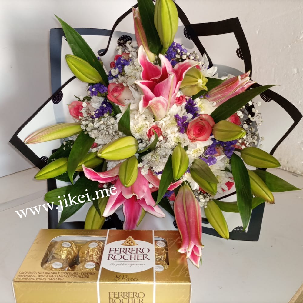 Lilies arrangement with tropical flowers