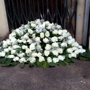 White rose sympathy wreath with baby's breath and greenery in Nairobi